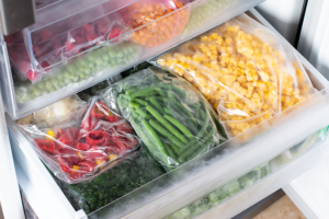 Frozen produce including green beans and corn in plastic bags
