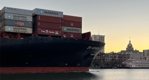 A huge cargo ship moves slowly down the Savannah River