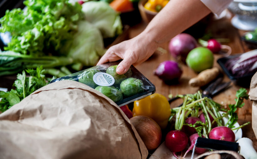 Freshly packaged vegetables are removed from a paper bag