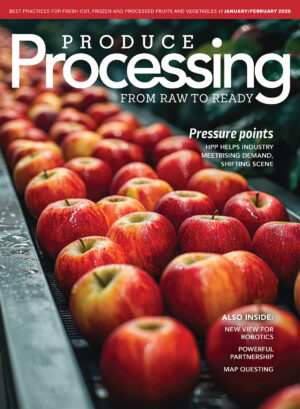 A magazine cover featuring ripe red apples on on a production line