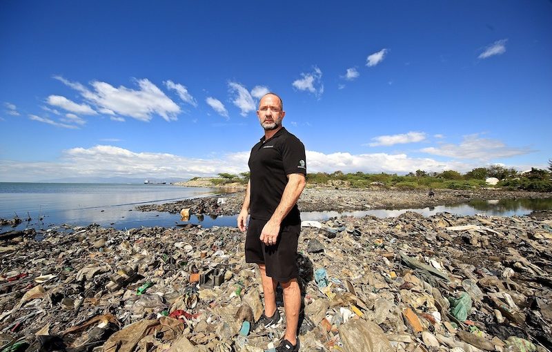 Plastic Bank Founder David Katz surrounded by ocean plastic