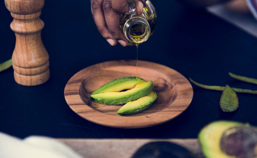 Oil is poured on fresh avocados