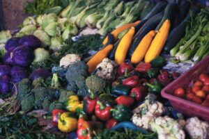 an array of colorful produce, including carrots, broccoli and bell peppers