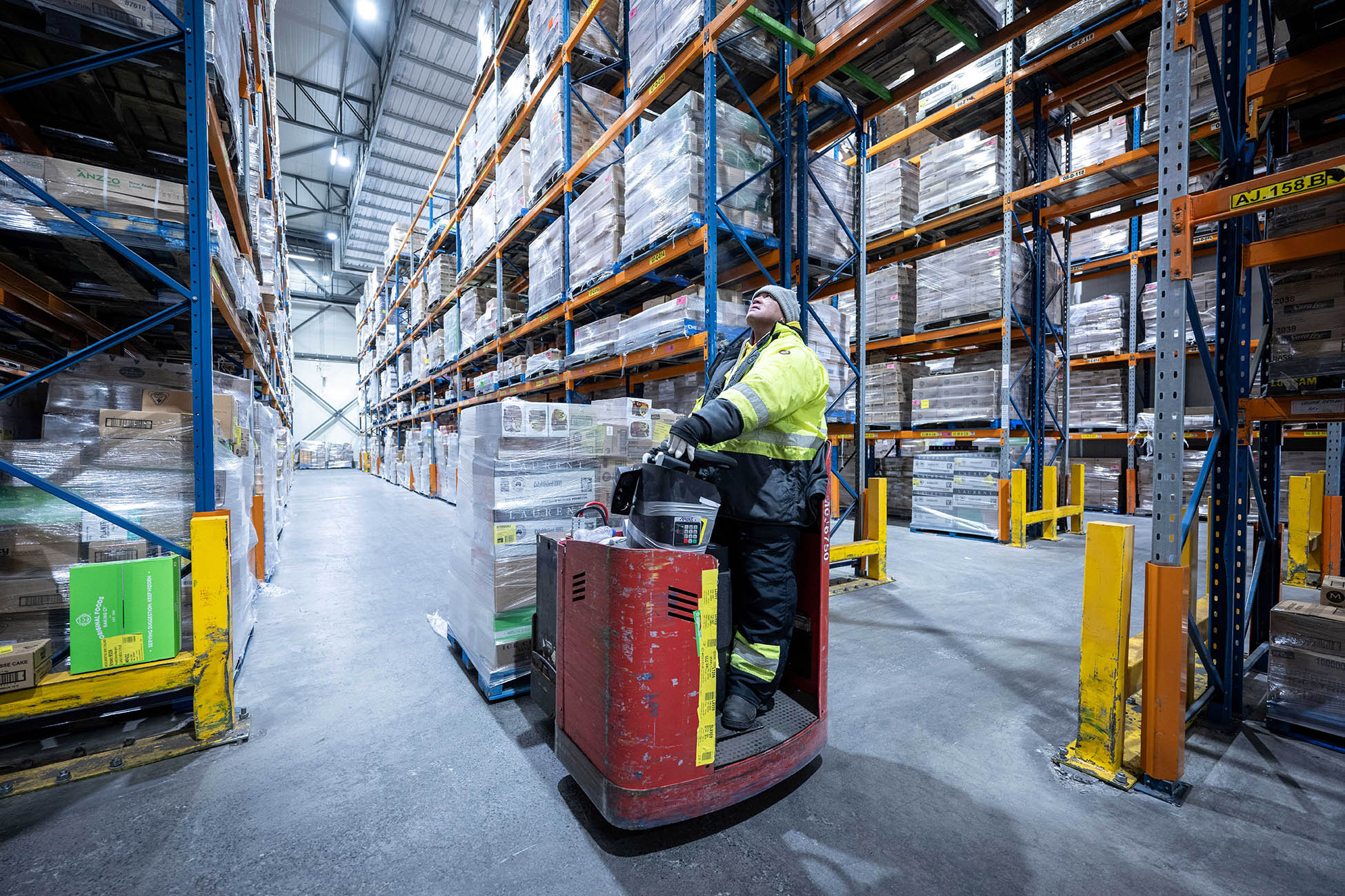 A worker navigates product delivery in a cold storage facility