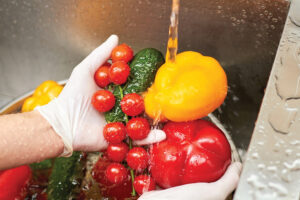 Fresh vegetables are washed in a sink 