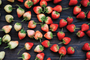A close-up of strawberries in varying degrees of ripeness